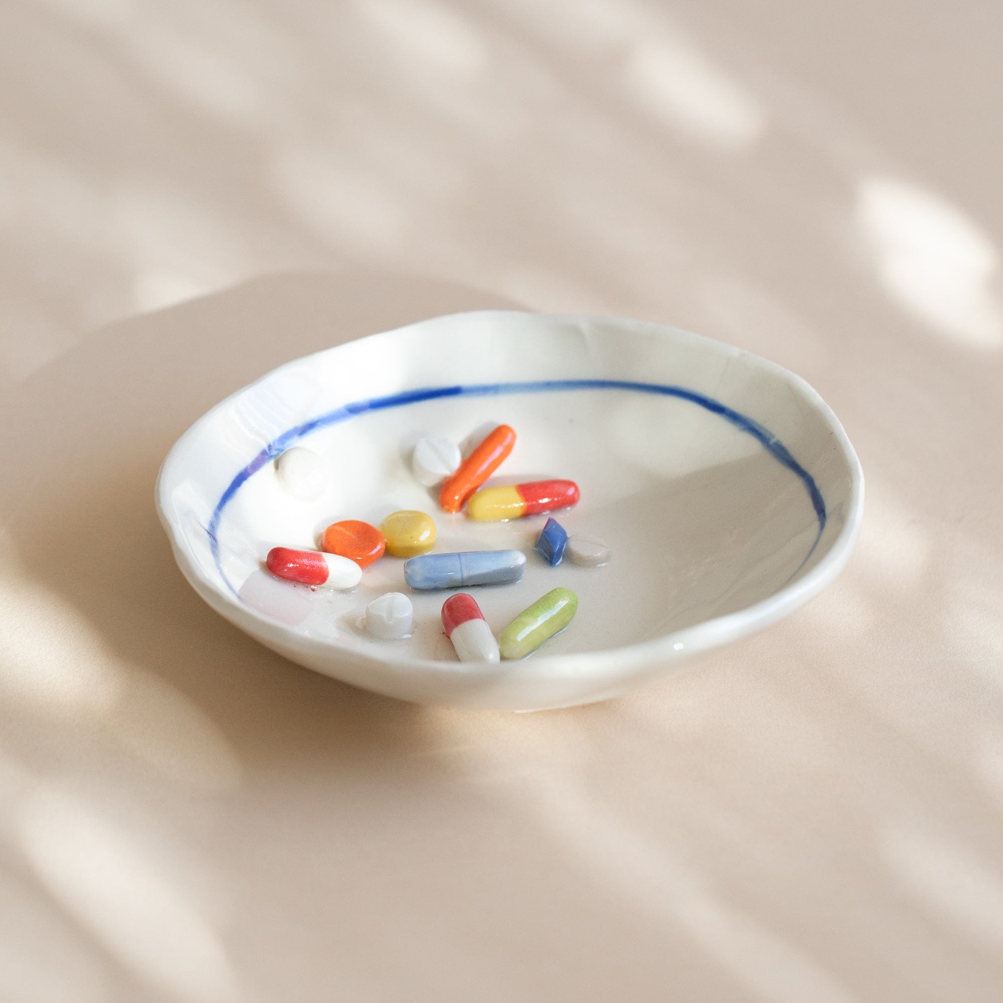 Pot Lady Objects Round with Blue Rim Ceramic Pill Plate