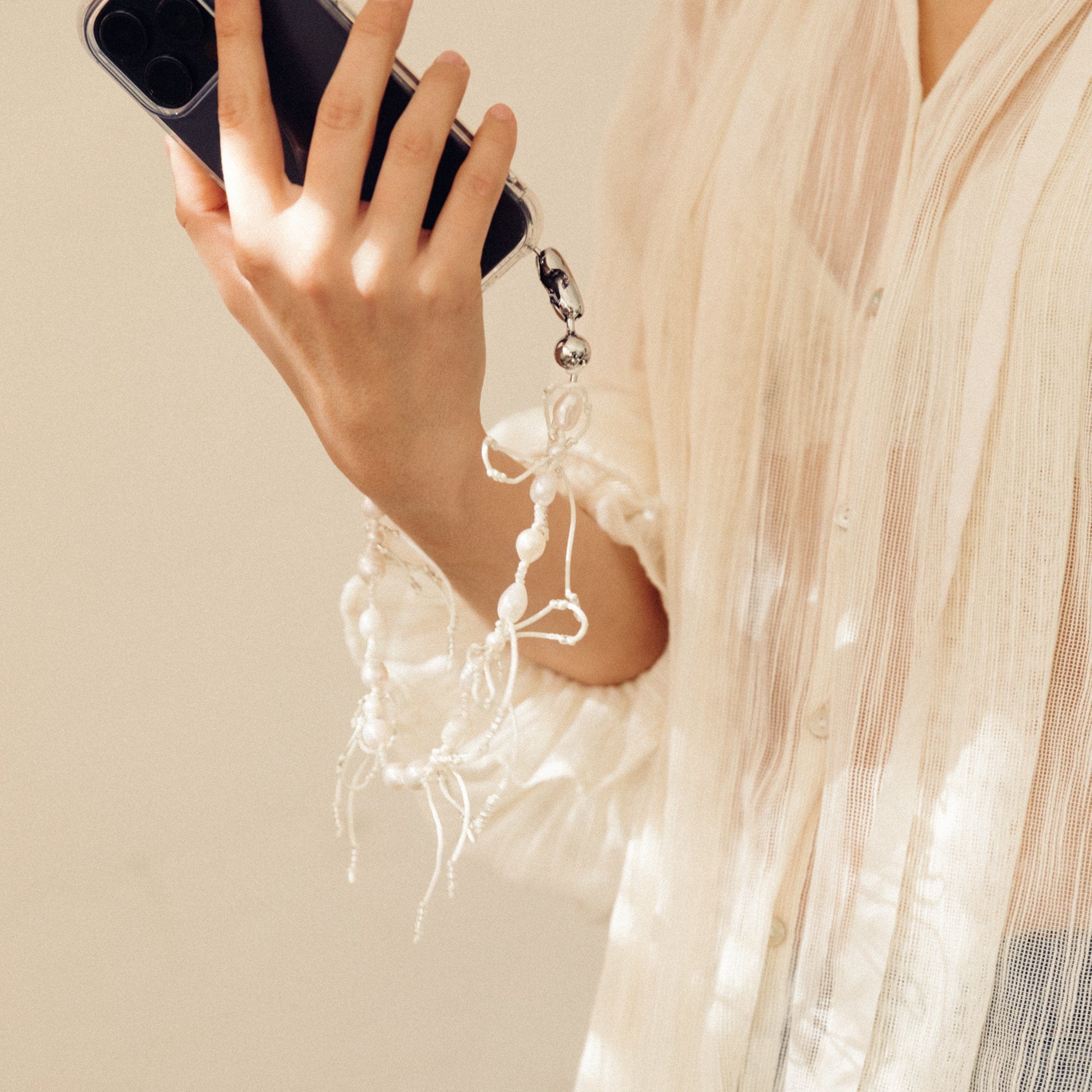 Ossa New York Tech Accessories Wristlet iPhone Cord in Pearl & Bow by Ossa