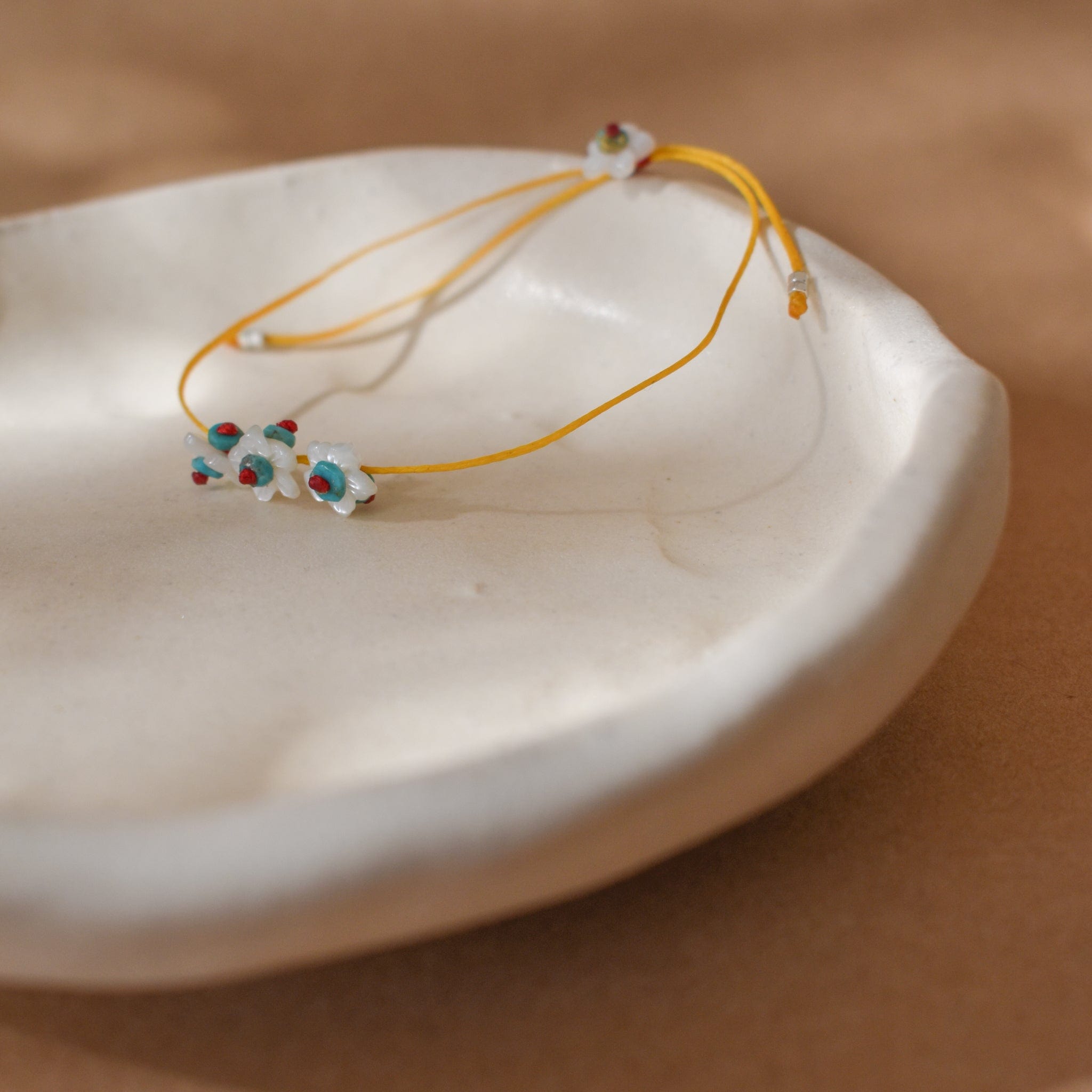 River Song Bracelets Tiny Treasures White Flowers Bracelet on Marigold Chord